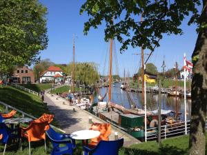 a group of tables and chairs next to a marina at Haus Margret in Carolinensiel