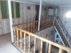 a wooden staircase in a room with a wall at Fayz Hotel in Bukhara