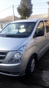 a small silver car parked in a parking lot at Fayz Hotel in Bukhara