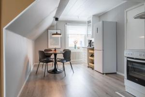 a kitchen with a table and chairs in a room at Guestly Homes - 2BR Central Charm in Boden