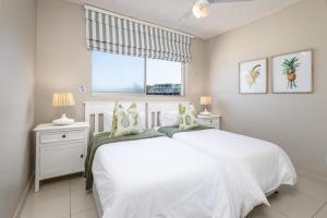 - une chambre avec un lit blanc et une fenêtre dans l'établissement 804 Marbella - by Stay in Umhlanga, à Durban