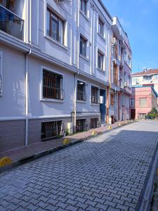 an empty street in front of a white building at Ottoman Sweet Home in Istanbul