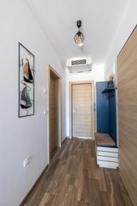 a hallway with white walls and wooden floors at ELINOR Apartments - B25 in St. St. Constantine and Helena +42 photos