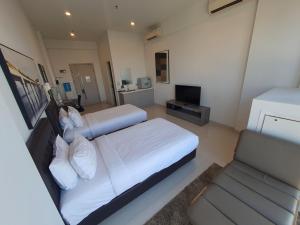 a large bedroom with two beds and a couch at The Bridge Club in Phnom Penh