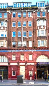 a large brick building with people walking in front of it at Fitzroy Royale Apart- London in London