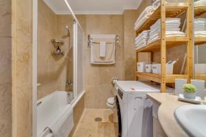 a bathroom with a tub and a sink and a toilet at Casita Bonita - with private garden near beach in Jávea in Jávea