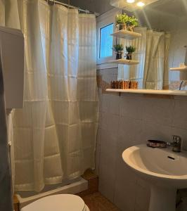 a bathroom with a shower curtain and a sink at SELO APARTMENTS in Nea Kalikratia