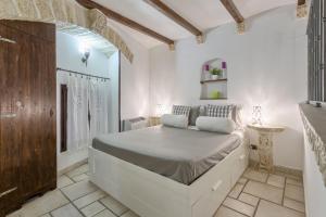 a white bedroom with a large bed in a room at Due Passi Dal Borgo Antico in Bari