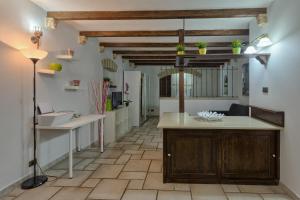 a kitchen with a table and a counter top at Due Passi Dal Borgo Antico in Bari +49 photos