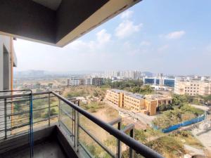a balcony with a view of a city at Private room in Blueridge in Hinjewadi