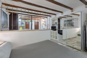 a bedroom with white walls and a large window at Due Passi Dal Borgo Antico in Bari