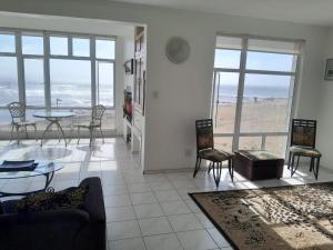 a living room with a view of the beach at Camere da Letto ON-THE-BEACH Self Catering in Swakopmund
