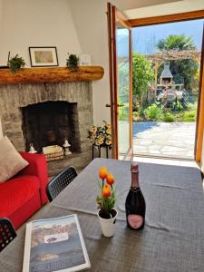 a living room with a table with a bottle of wine at Ca' Sunin Bellagio - mountains view apartment in Bellagio