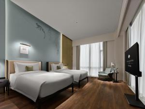 Postel nebo postele na pokoji v ubytování Maison Albar Hotels Leshan