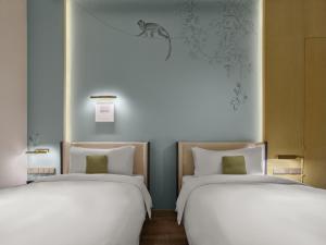 Postel nebo postele na pokoji v ubytování Maison Albar Hotels Leshan
