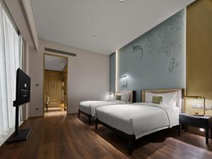 Postel nebo postele na pokoji v ubytování Maison Albar Hotels Leshan