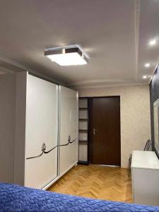 a room with a bed and a closet and a door at Dighomi Apartment in Tbilisi City