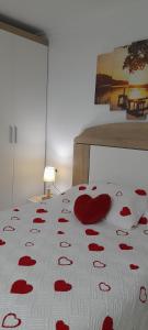 a bed with red hearts on a white blanket at Estudio La Corbeta in Torrox Costa