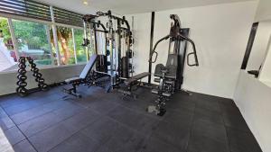 a gym with several tread machines in a room at Lamai Buri Resort in Lamai