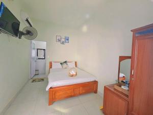 a small bedroom with a bed and a mirror at Minh Minh Homestay in Con Dao +24 photos