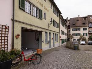 a red bike parked in front of a building at Hotel Adler in Stein am Rhein
