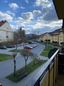 a view from a balcony of a parking lot at Apartament Asspazja in Stronie Śląskie