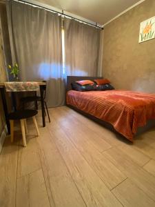 a bedroom with a bed and a table in it at Apartament Asspazja in Stronie Śląskie