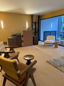 a living room with chairs and a large window at Alinea Market Agora Square in Limassol