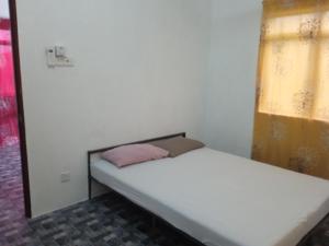 a small bed in a room with a window at Homestay Idaman B B with 2 room aircond 2 Quen Bed and Not Sharing Room -Privacy in Kuala Terengganu