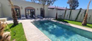a swimming pool in the backyard of a house at Villa BALI KECH in Marrakech