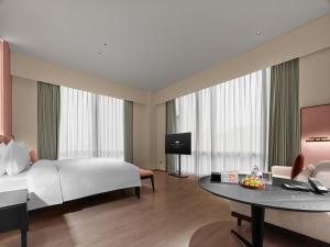 Postel nebo postele na pokoji v ubytování Maison Albar Hotels Leshan
