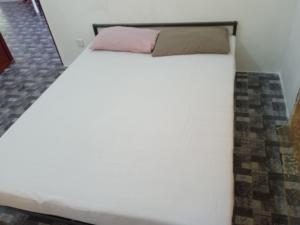 a large white bed in a room at Homestay Idaman B B with 2 room aircond 2 Quen Bed and Not Sharing Room -Privacy in Kuala Terengganu