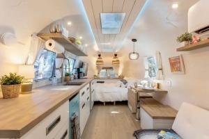 a kitchen with a sink and a living room at South Tampa Airstream Farm Stay in Tampa