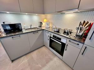 a kitchen with white cabinets and a counter top at Flat in Bulle, Switzerland in Bulle