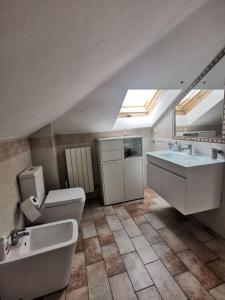 a large bathroom with a sink and a toilet and a sink at Appartamento mansardato Civitanova Marche in Civitanova Marche