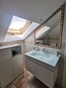 a bathroom with a sink and a large mirror at Appartamento mansardato Civitanova Marche in Civitanova Marche