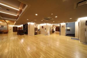 a large room with a wooden floor in a building at Saga Grace Hotel in Kyoto