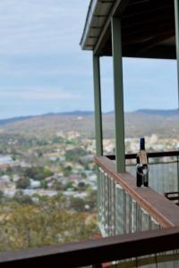 a bottle of wine sitting on the edge of a balcony at Eagle's Nest in Stanthorpe