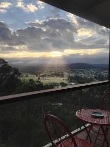 a table and chairs on a balcony with a view at Eagle's Nest in Stanthorpe