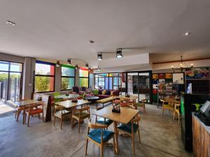 a restaurant with tables and chairs and windows at Next To Apartment Hotel in Pretoria