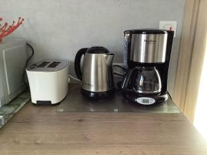 two coffee makers sitting on a counter next to a toaster at Le chouette gîte in Sélestat