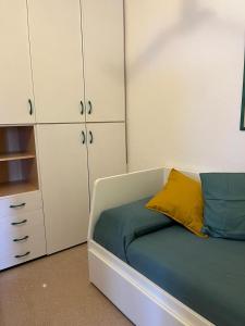 a bedroom with a bed and white cabinets at Uno Sguardo sulla Pelosa in Stintino