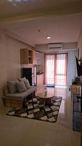 a living room with a couch and a table at 2 BR The Oak Tower Apartment 9th Floor in Jakarta