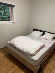 a bed sitting in a room with a window at Chalet et étangs 2 chambres in Henrichemont