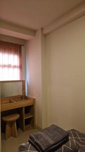 a room with a sink and a table and a stool at 2 BR The Oak Tower Apartment 9th Floor in Jakarta
