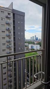 a balcony of a building with a view of a city at 2 BR The Oak Tower Apartment 9th Floor in Jakarta