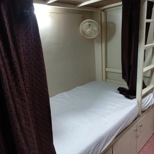 a bedroom with a bunk bed with a curtain at New Assar International dormitory in Mumbai