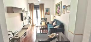 a living room with a couch and a table at Delux Center Punta Umbría in Punta Umbría