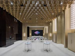 a large hall with tables and a projection screen at Maison Albar Hotels Leshan in Leshan