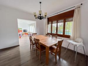 a dining room with a wooden table and chairs at Espectacular casa con piscina en Tordera in Tordera